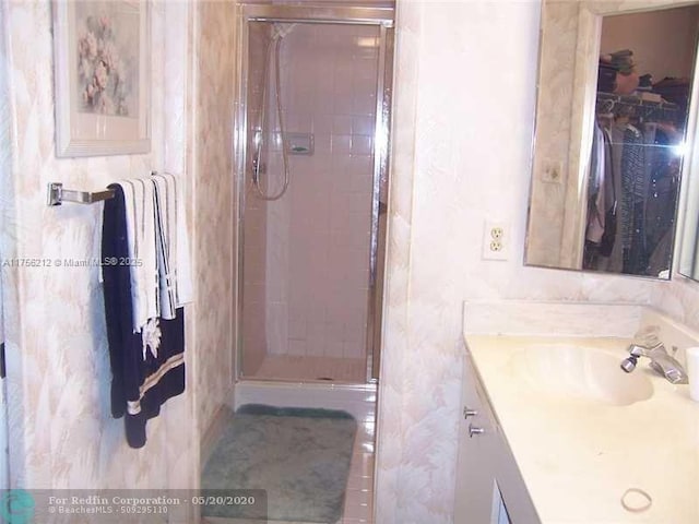 bathroom featuring a stall shower and vanity