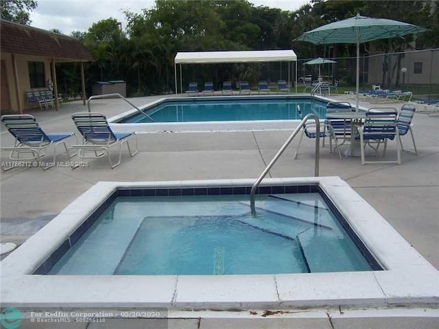 community pool featuring a patio area