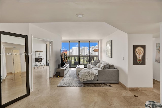 living room with expansive windows and baseboards