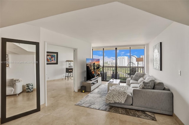 living room featuring expansive windows and baseboards