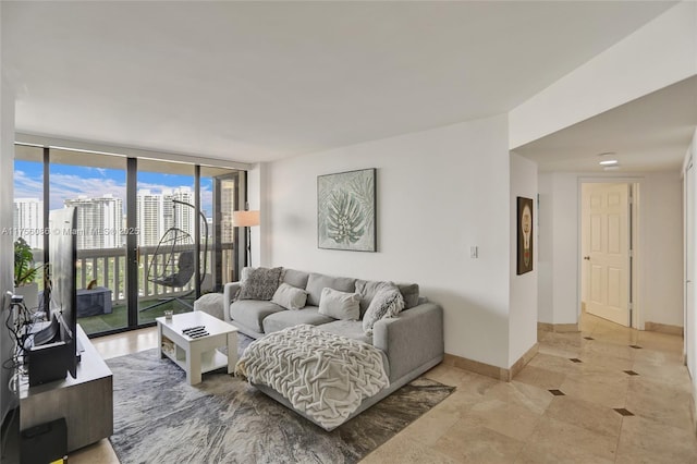 living area with expansive windows and baseboards