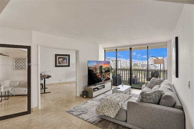 living area with baseboards and floor to ceiling windows