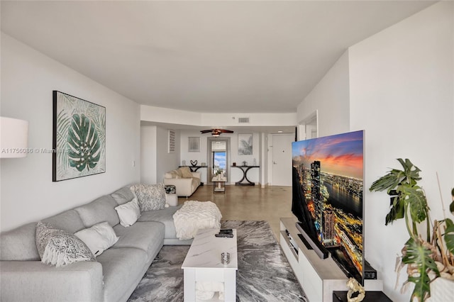 living area featuring a ceiling fan and visible vents