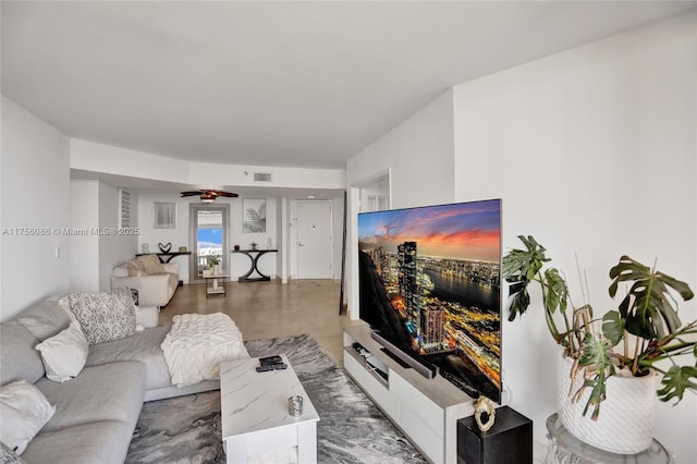 living area featuring ceiling fan, concrete floors, and visible vents