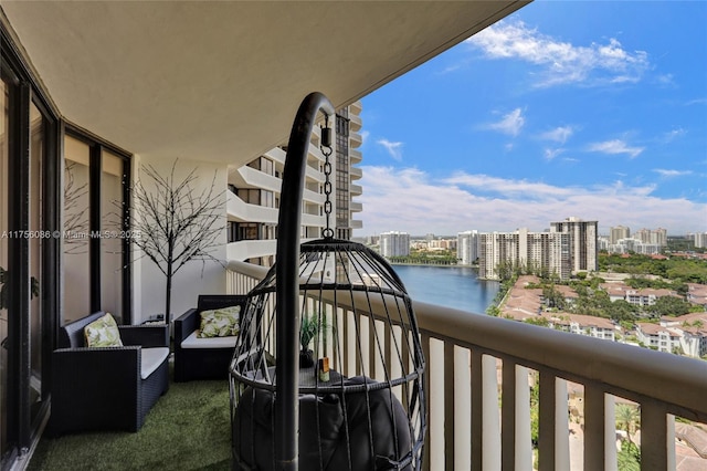 balcony featuring a view of city and a water view