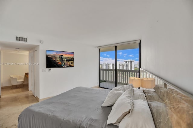 bedroom with access to outside, visible vents, and expansive windows