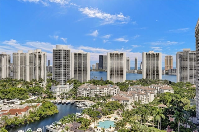 birds eye view of property with a water view and a city view