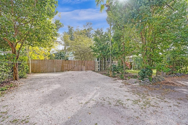 view of patio / terrace featuring gravel driveway, a gate, and fence