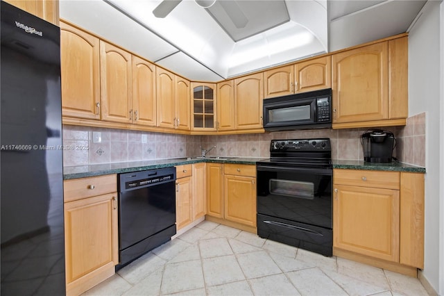 kitchen featuring black appliances, ceiling fan, glass insert cabinets, and decorative backsplash