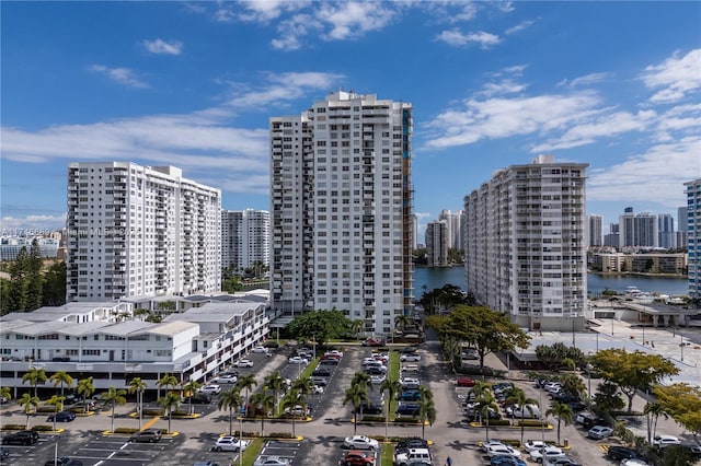 birds eye view of property featuring a water view and a view of city