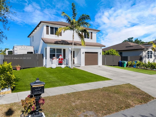 view of front of house with driveway, a garage, fence, a front yard, and stucco siding