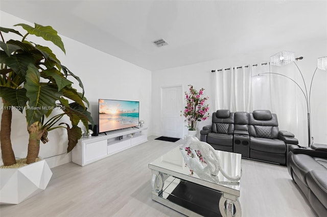 living area featuring light wood-type flooring and visible vents