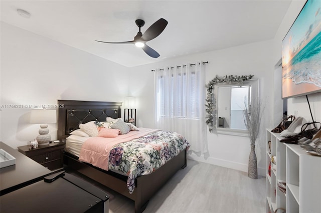 bedroom featuring ceiling fan, baseboards, and wood finished floors