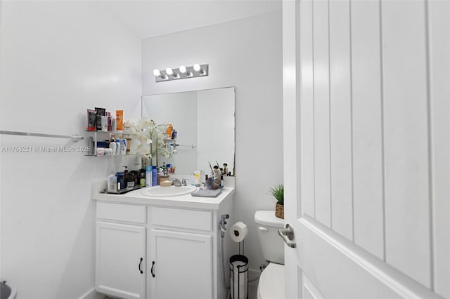 half bathroom with toilet and vanity