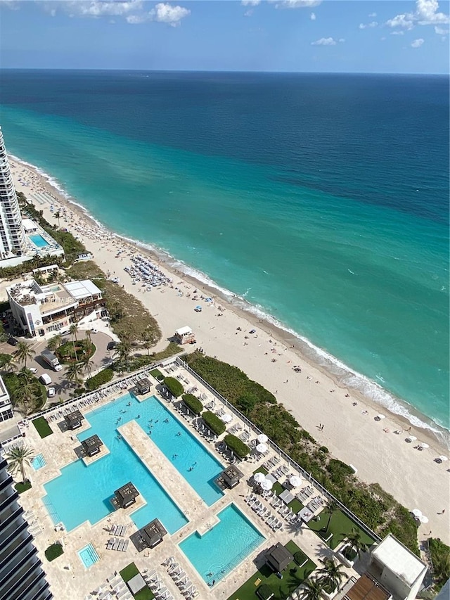 drone / aerial view with a beach view and a water view