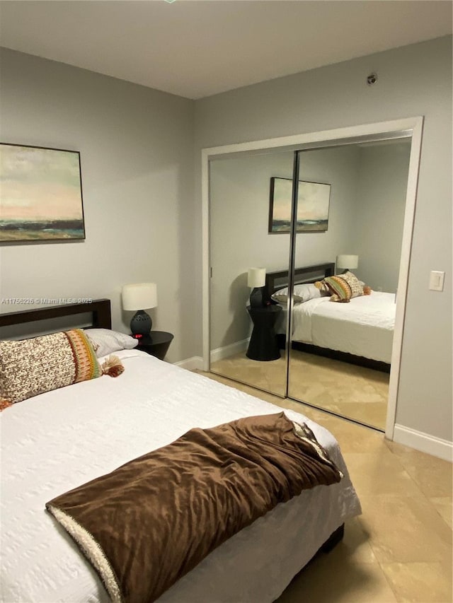 bedroom featuring a closet and baseboards