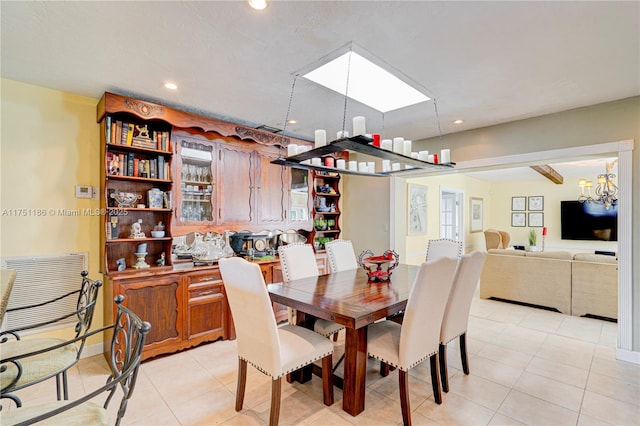 dining space with an inviting chandelier, light tile patterned floors, and recessed lighting