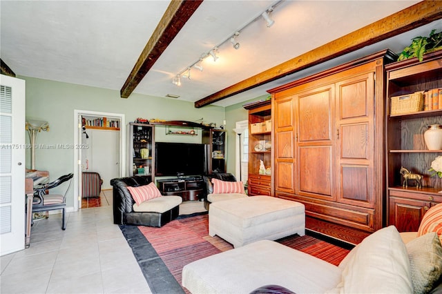 living area with rail lighting, beam ceiling, and light tile patterned floors