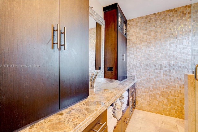 full bathroom featuring tile patterned flooring, tile walls, and vanity