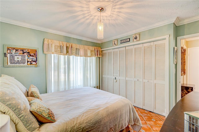 bedroom with tile patterned floors, a closet, and ornamental molding