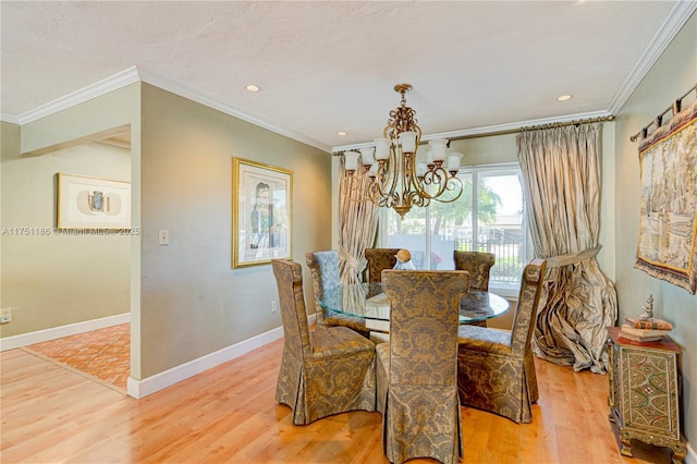 dining room with baseboards, a notable chandelier, wood finished floors, and ornamental molding