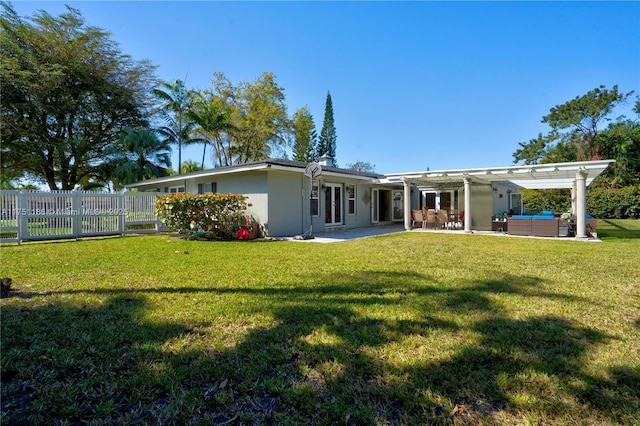 rear view of house with outdoor lounge area, a patio area, a yard, and fence