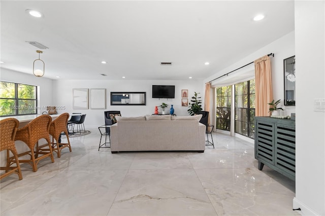 living room with marble finish floor, visible vents, and recessed lighting