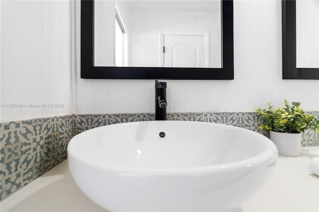 bathroom with a freestanding tub and a sink