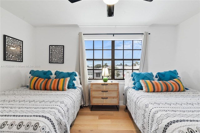 bedroom with ceiling fan and light wood-style flooring