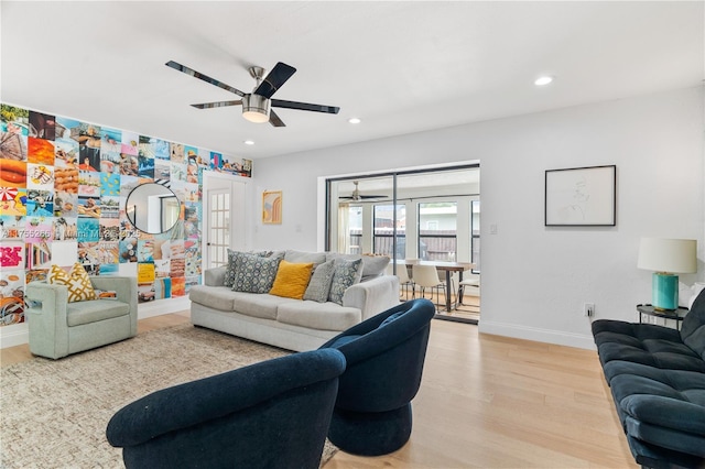 living area featuring light wood-style flooring, baseboards, a ceiling fan, and recessed lighting