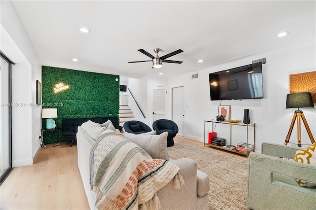 living room featuring stairway, wood finished floors, visible vents, and recessed lighting