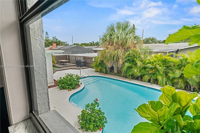 view of pool featuring a fenced in pool, fence, and a patio