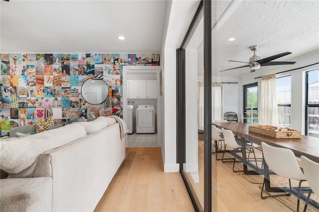 living area with recessed lighting, light wood-style flooring, a ceiling fan, a textured ceiling, and separate washer and dryer