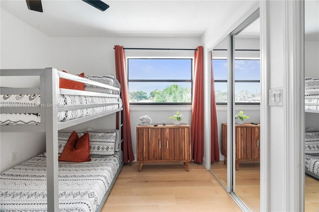 bedroom with light wood-style floors and a ceiling fan