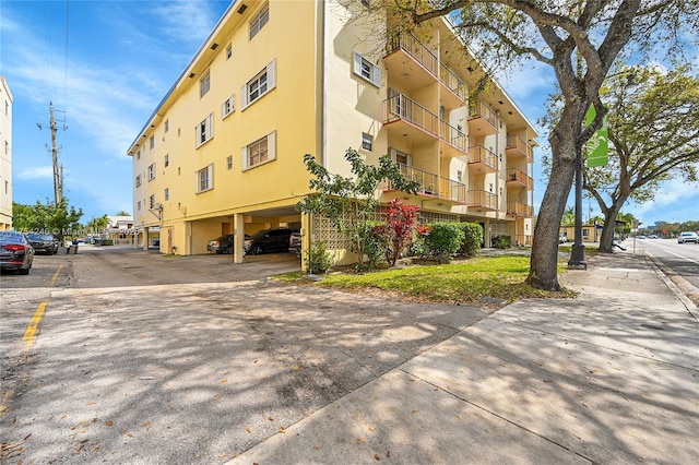 view of property featuring uncovered parking