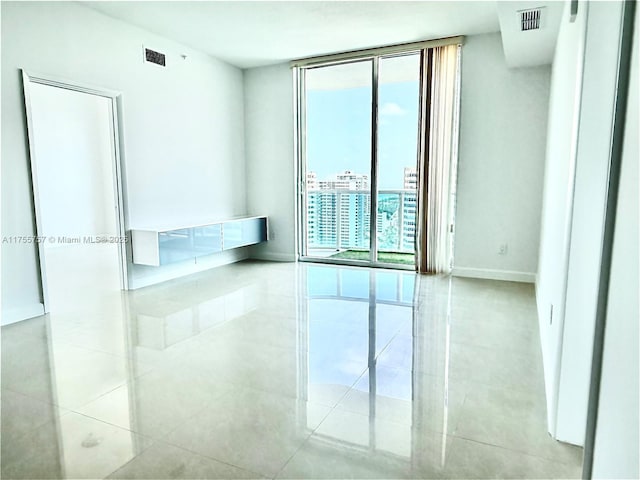 1945 S Ocean Dr Unit 2103, Hallandale Beach, FL 33009 - unfurnished room with floor to ceiling windows and tile patterned floors