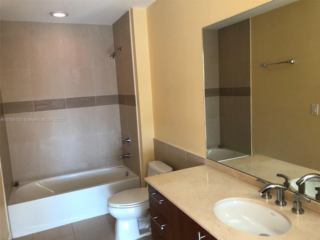 full bath featuring washtub / shower combination, tile patterned flooring, vanity, and toilet