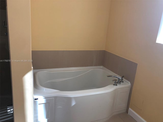 bathroom featuring a bath and tile patterned floors