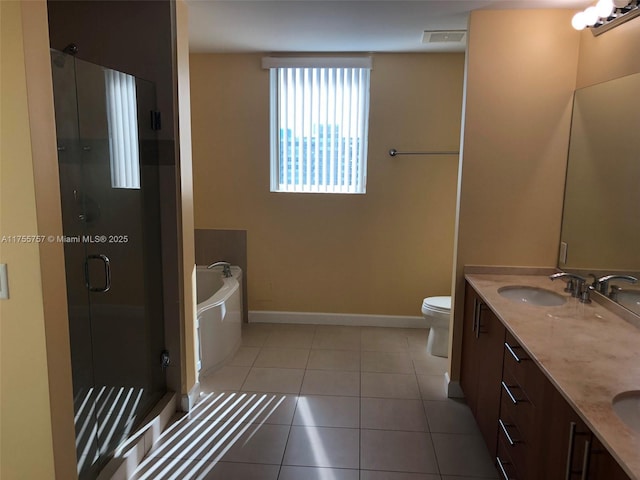 bathroom featuring tile patterned flooring, a sink, baseboards, a shower stall, and a bath