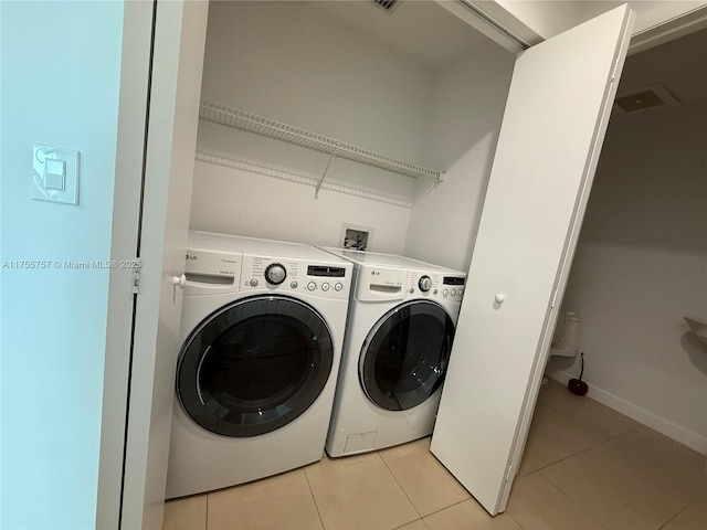 1945 S Ocean Dr Unit 2103, Hallandale Beach, FL 33009 - washroom featuring separate washer and dryer and light tile patterned flooring