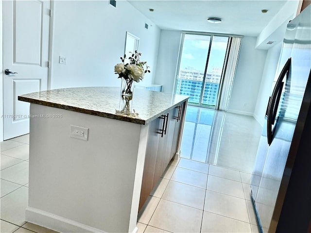 1945 S Ocean Dr Unit 2103, Hallandale Beach, FL 33009 - kitchen featuring stainless steel fridge, a kitchen island, light tile patterned floors, and modern cabinets