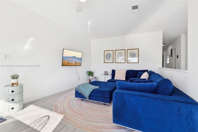 living room with visible vents and wood finished floors