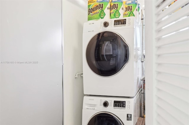 clothes washing area with laundry area and stacked washer / dryer