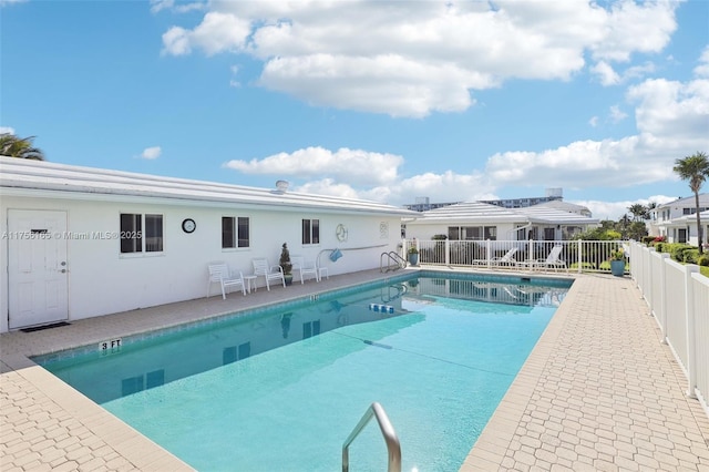 view of swimming pool with fence, a fenced in pool, and a patio