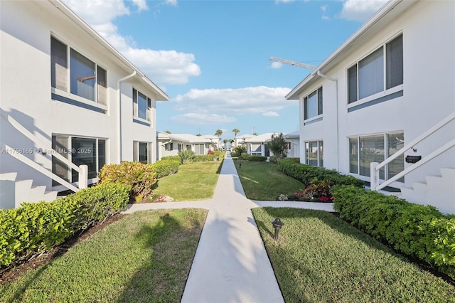 view of property's community with a residential view and a yard