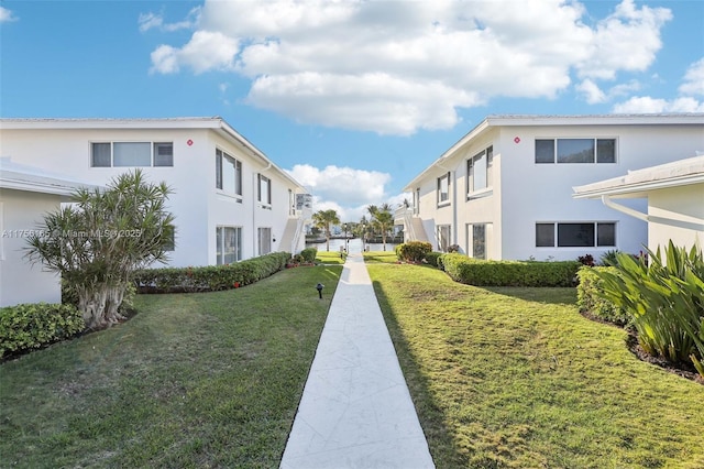 view of home's community with a lawn