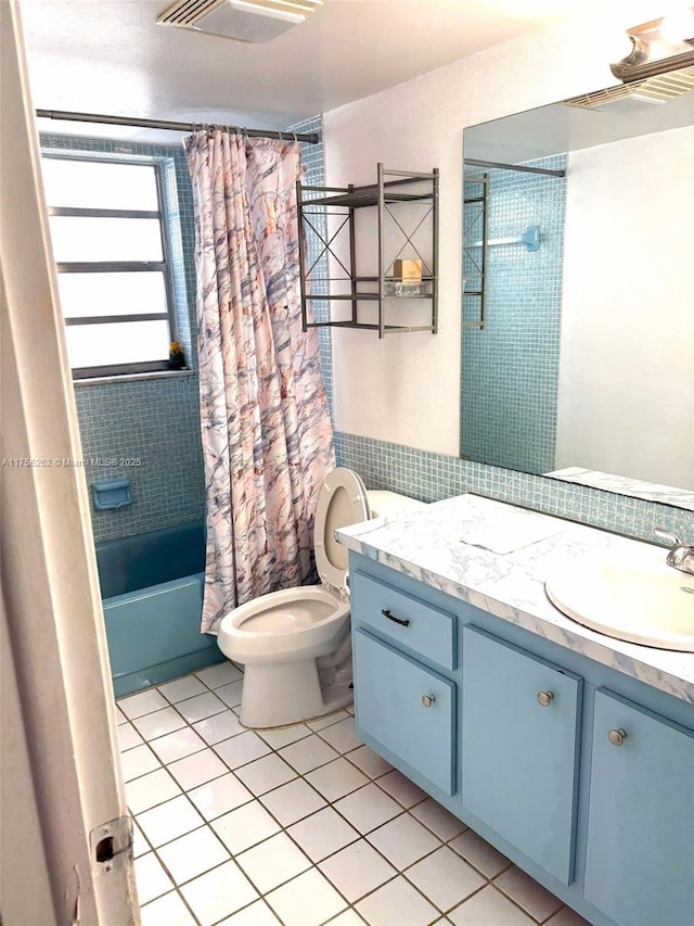 bathroom featuring shower / tub combo, visible vents, toilet, tile patterned flooring, and vanity