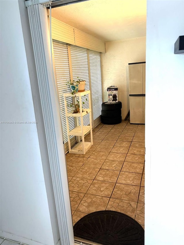 corridor featuring light tile patterned floors