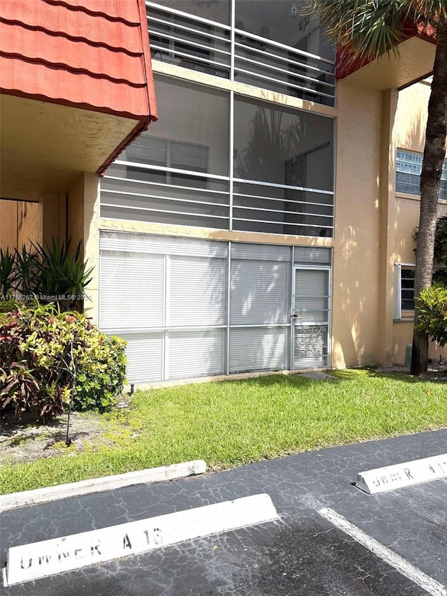 exterior space featuring uncovered parking and stucco siding