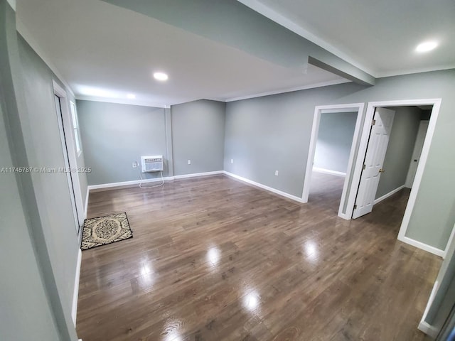 spare room featuring crown molding, baseboards, wood finished floors, and recessed lighting